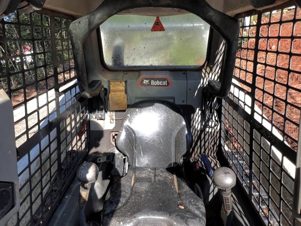 Before: dusty, muddy Bobcat cab interior and seat