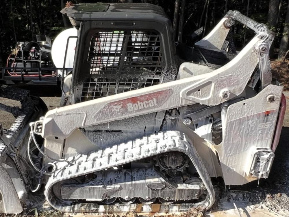 Mid-wash: Bobcat T66 covered in cleaning foam
