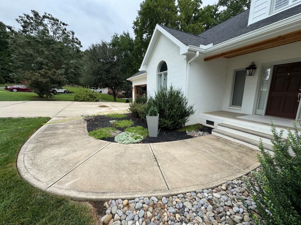 Before: dull, stained curved front walkway at a white brick house