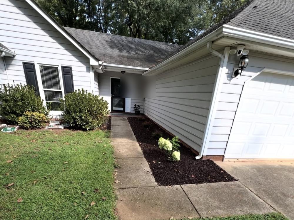 Before: front walkway of a vinyl-siding home, from the driveway job